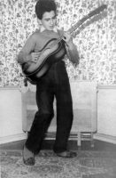 George Harrison playing the guitar, circa 1950