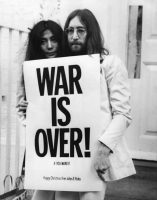 John Lennon and Yoko Ono with a War Is Over! poster, December 1969